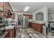 Spacious kitchen with stainless appliances, wooden cabinets, and an open layout to the living area at 119 Marietta Rd, Mooresville, NC 28117