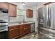 Close up of kitchen area with stainless appliances and wooden cabinets, with large window at 119 Marietta Rd, Mooresville, NC 28117