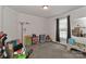 This room with neutral walls and carpet is staged with toys, ready to be a play area at 119 Marietta Rd, Mooresville, NC 28117
