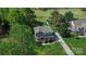Aerial view of the house nestled amongst green trees with a lush green front lawn at 136 Wood Duck Loop, Mooresville, NC 28117