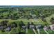 Aerial view of neighborhood homes, golf course, lush trees, and a glimpse of the lake at 136 Wood Duck Loop, Mooresville, NC 28117