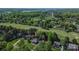 Wide angle aerial view of a neighborhood with lush green lawns, golf course and lake at 136 Wood Duck Loop, Mooresville, NC 28117