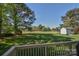 Expansive backyard with lush green grass, a storage shed, and a bright blue trampoline offers ample space at 136 Wood Duck Loop, Mooresville, NC 28117