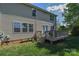 View of the home's backyard featuring a raised deck and fenced backyard at 136 Wood Duck Loop, Mooresville, NC 28117