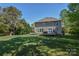 Green backyard with a home that has a wooden deck and sliding glass doors at 136 Wood Duck Loop, Mooresville, NC 28117