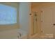 Bathroom featuring a tub, shower, and window at 136 Wood Duck Loop, Mooresville, NC 28117