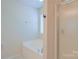 Bright bathroom featuring a soaking tub under a window and a glass-enclosed shower at 136 Wood Duck Loop, Mooresville, NC 28117