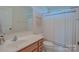 Bright bathroom showcasing a single vanity, toilet, and shower with curtain at 136 Wood Duck Loop, Mooresville, NC 28117
