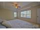 Bright bedroom with a tray ceiling, ceiling fan, and many windows at 136 Wood Duck Loop, Mooresville, NC 28117