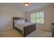 Bedroom showcasing a queen-sized bed, a dark-toned headboard, and a bright window at 136 Wood Duck Loop, Mooresville, NC 28117