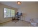 Bedroom setup as a functional office space with a large window for natural light at 136 Wood Duck Loop, Mooresville, NC 28117
