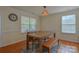 Cozy dining room with hardwood floors, a wooden table with bench, and natural light at 136 Wood Duck Loop, Mooresville, NC 28117