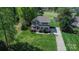 Charming two-story home featuring lush landscaping and a well-manicured lawn at 136 Wood Duck Loop, Mooresville, NC 28117