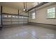 Spacious two car garage with epoxy flooring and two windows for ample natural lighting at 136 Wood Duck Loop, Mooresville, NC 28117