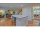 Open-concept kitchen with an island, bar seating, and seamless flow into the living area at 136 Wood Duck Loop, Mooresville, NC 28117