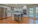 Bright kitchen featuring a center island, stainless steel appliances, and white cabinetry at 136 Wood Duck Loop, Mooresville, NC 28117
