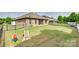 Large backyard featuring green grass, a fenced perimeter, and a playset at 14113 Highland Meadow Rd, Charlotte, NC 28273
