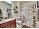 Well-lit bathroom featuring a vanity with granite countertop and decorative shower curtain at 14113 Highland Meadow Rd, Charlotte, NC 28273