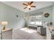 Light-filled bedroom with a ceiling fan, carpet flooring, and a window seat at 14113 Highland Meadow Rd, Charlotte, NC 28273