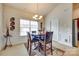 Inviting dining room with a round wooden table set for four, chandelier, and decorative wall art at 14113 Highland Meadow Rd, Charlotte, NC 28273