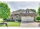 Charming brick home featuring an attached two-car garage, manicured lawn, and an inviting front entrance at 14113 Highland Meadow Rd, Charlotte, NC 28273