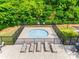 Relaxing hot tub complete with lounge chairs and shaded tables at 14113 Highland Meadow Rd, Charlotte, NC 28273