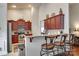Open kitchen with wooden cabinets, granite countertops, and a breakfast bar with three stools at 14113 Highland Meadow Rd, Charlotte, NC 28273