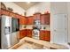 Cozy kitchen with stainless steel appliances, wooden cabinets, tile flooring, and recessed lighting at 14113 Highland Meadow Rd, Charlotte, NC 28273