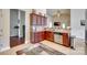 Well-lit kitchen with stainless steel appliances, wooden cabinets, and tiled floors at 14113 Highland Meadow Rd, Charlotte, NC 28273
