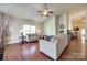 Spacious living room with hardwood floors, neutral walls, and comfortable sofas under a ceiling fan at 14113 Highland Meadow Rd, Charlotte, NC 28273