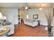 Open living room with hardwood floors, comfortable seating, and neutral decor under a ceiling fan at 14113 Highland Meadow Rd, Charlotte, NC 28273