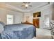 Serene main bedroom featuring a wooden bed, a dresser, and a ceiling fan above a neutral carpet at 14113 Highland Meadow Rd, Charlotte, NC 28273