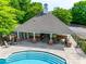 Relaxing pool area with lounge chairs, tables, and an open air clubhouse at 14113 Highland Meadow Rd, Charlotte, NC 28273