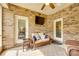 Comfortable sunroom with wicker furniture, brick walls, and access to the outdoors at 14113 Highland Meadow Rd, Charlotte, NC 28273