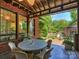 Relaxing covered back porch with brick columns and a view of the landscaped backyard at 1413 Devon Dr, Charlotte, NC 28209