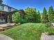 Beautiful backyard with lush green lawn, mature trees, and access to a cozy outdoor deck at 1413 Devon Dr, Charlotte, NC 28209