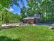 Expansive backyard featuring a pool, lush lawn, and a stylish outdoor seating area perfect for entertaining at 1413 Devon Dr, Charlotte, NC 28209
