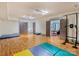 Finished basement area with hardwood floors, workout space, and access to additional living area at 1413 Devon Dr, Charlotte, NC 28209