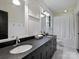 Elegant bathroom with double sinks, modern fixtures, and a shower-tub combination at 1413 Devon Dr, Charlotte, NC 28209