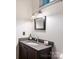 Charming bathroom featuring updated vanity, granite countertop, and modern lighting fixtures at 1413 Devon Dr, Charlotte, NC 28209
