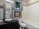 Bathroom featuring a vanity with an oval sink, a framed painting, and a shower and tub combination at 1413 Devon Dr, Charlotte, NC 28209