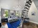 Modern bedroom with a custom loft ladder, chic chandelier, and abundant natural light at 1413 Devon Dr, Charlotte, NC 28209