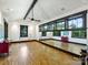 Bright bonus room with hardwood floors, ample natural light, and mirror for ballet/dance at 1413 Devon Dr, Charlotte, NC 28209