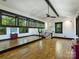 Spacious bonus room with high ceilings, hardwood floors, and a wall of windows offering great views at 1413 Devon Dr, Charlotte, NC 28209