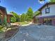 Home exterior showcases a private driveway, basketball hoop, brick accents, and manicured landscaping at 1413 Devon Dr, Charlotte, NC 28209