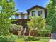 Beautiful home exterior featuring a brick base, landscaped yard, and inviting wooden steps to the front door at 1413 Devon Dr, Charlotte, NC 28209