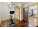 Home gym with exercise bike and wall climbing bars, leading into a well lit office at 1413 Devon Dr, Charlotte, NC 28209