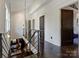 Hallway with hardwood floors and dark metal railings connects multiple rooms creating an open and airy feel at 1413 Devon Dr, Charlotte, NC 28209