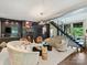 Upscale living room with a stylish fireplace, art and open staircase at 1413 Devon Dr, Charlotte, NC 28209