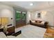 Cozy living room with a comfortable sofa, wooden floors, and a view of the lush outdoors at 1413 Devon Dr, Charlotte, NC 28209
